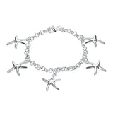 Silver bracelet with starfish charms on a white background