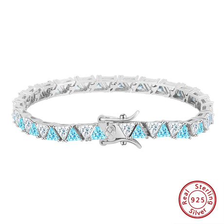 Silver bracelet with blue and clear gemstones on a white background, featuring a 'Real Sterling Silver' stamp.