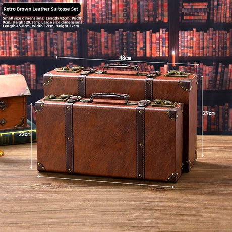 Retro brown leather suitcase set on a wooden surface with dimensions displayed.