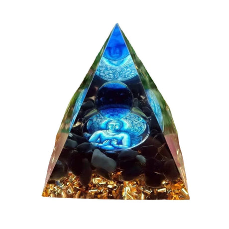 Triangular orgone pyramid with glowing blue Buddha figure inside on a white background