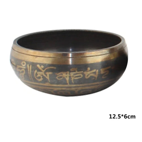 Bronze singing bowl with engraved text on a white background