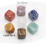 Set of colorful topaz cubes with size indication on a white background