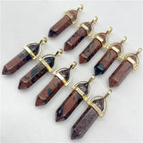 Set of stone pendants with gold accents on a light gray background