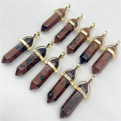 Set of stone pendants with gold accents on a light gray background