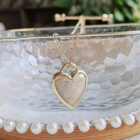 Necklace with a heart-shaped pendant on a decorative surface