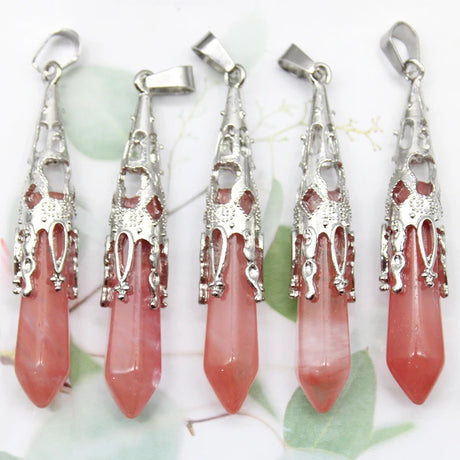 Five pink stone pendants with silver tops on a white background