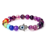 Colorful beaded bracelet with a Hamsa hand charm on a white background