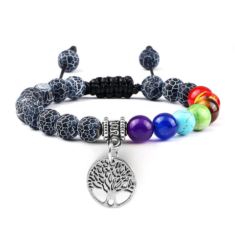 Multicolored beaded bracelet with a tree of life charm on a white background
