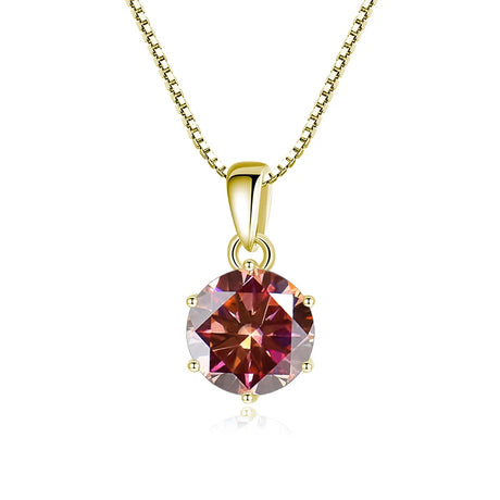 Gold necklace with a round red gemstone pendant on a white background