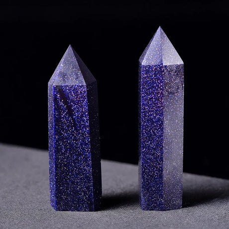 Two crystal towers with blue and gray colors on a dark background