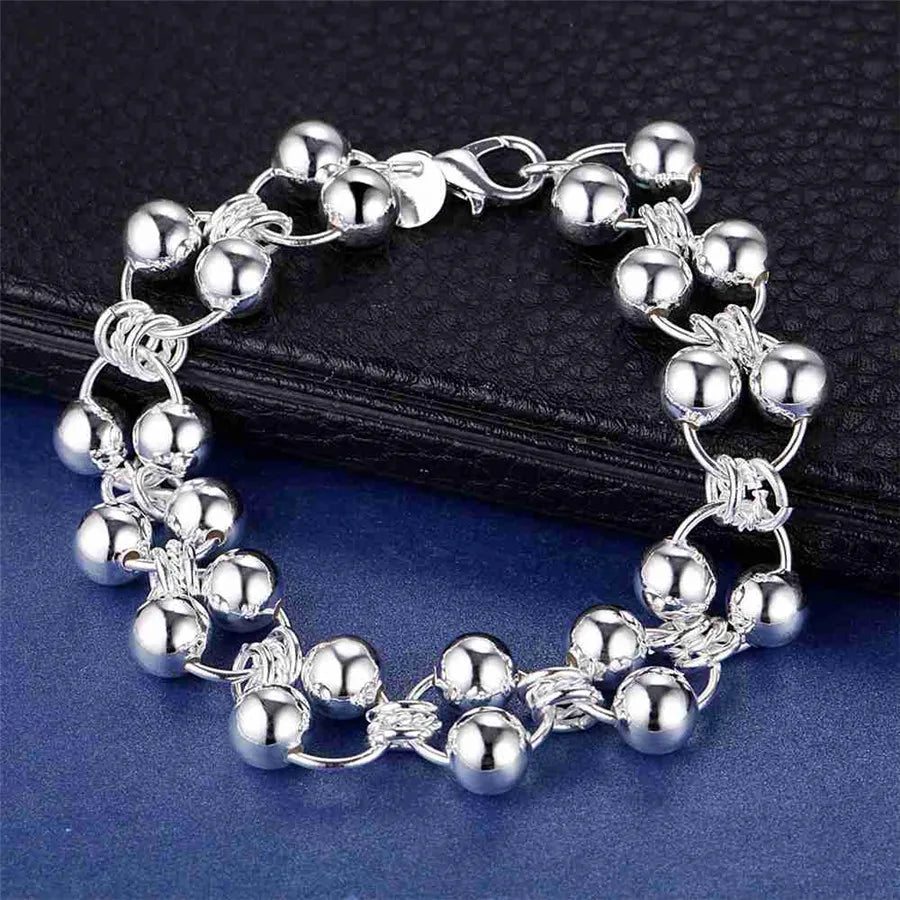 Silver bracelet with beads on a dark surface