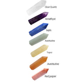 Collection of crystal wands with labels indicating their names and colors on a white background.