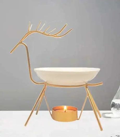 Decorative candle holder shaped like a deer with a white bowl and lit candle on a gray background