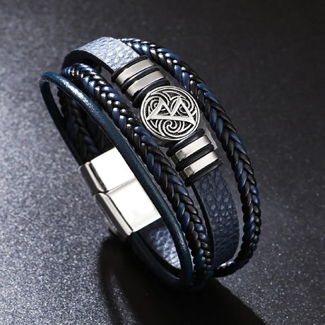 Black braided leather bracelet with silver emblem on a dark background