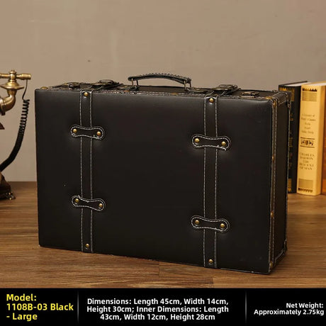 Black leather suitcase with gold accents on a wooden surface, with dimensions and weight information displayed.
