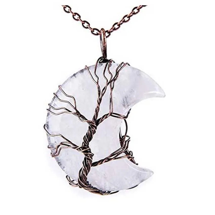Crescent moon-shaped pendant with tree design on a white background