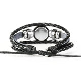 Black braided leather bracelet with silver beads on a white background