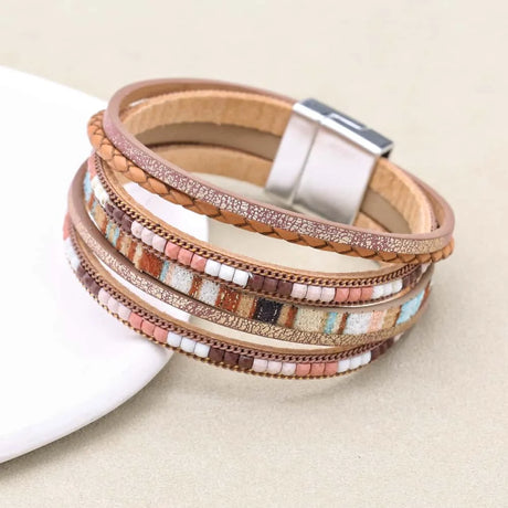 Multistrand beaded bracelet with a magnetic clasp on a beige background