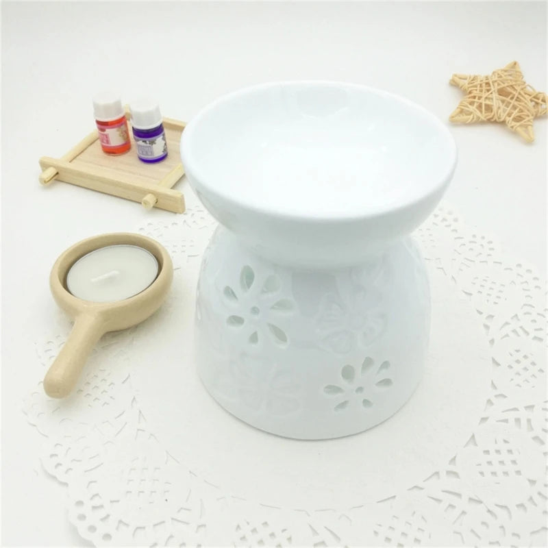White ceramic diffuser with floral patterns on a textured surface