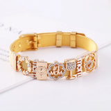 Gold dog collar with decorative charms on a white surface