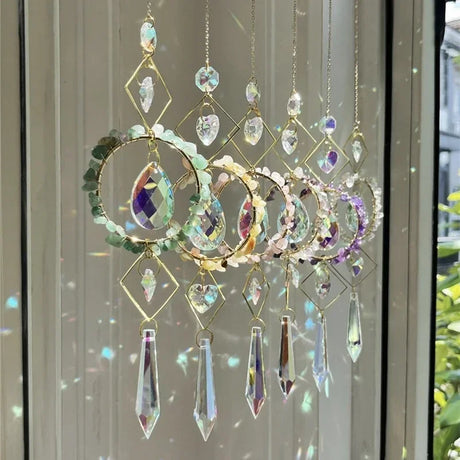 Decorative crystal hanging ornament with colorful gemstones in front of a window.