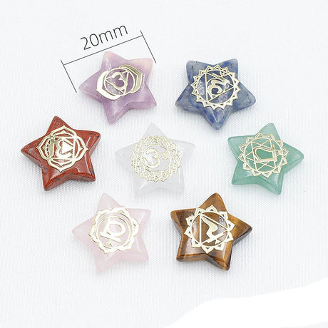 Star-shaped crystal pendants with gold symbols on a white background