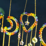 Colorful beaded heart and moon-shaped earrings on a dark background