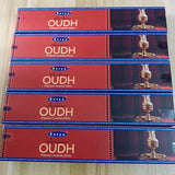 Multiple packages of Satya Arabian Oudh Premium Incense Sticks on a light wooden surface.