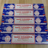 Multiple boxes of Satya Nag Champa Agarbatti on a wooden surface