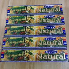 Multiple packages of Satya Natural Agarbatti on a wooden surface
