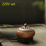Ceramic incense burner with a power cord on a wooden surface, labeled '220V set'.