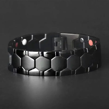 Black hexagonal patterned bracelet on a dark background