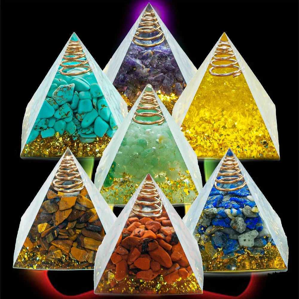 Pyramid-shaped crystal containers with colorful stones inside on a black background
