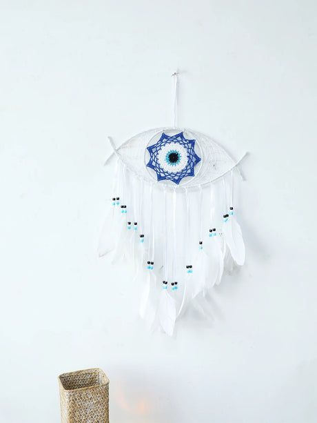 White dreamcatcher with blue center and feathers on a white background