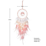 Dreamcatcher with feathers and measurements on a white background