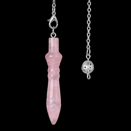 Pink crystal pendant on a silver chain against a black background