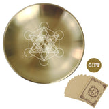 Gold plate with geometric design and brown cards on a white background