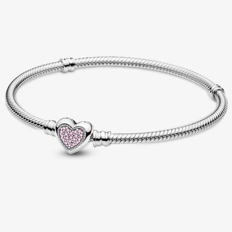 Silver bracelet with a heart-shaped charm featuring pink stones on a white background