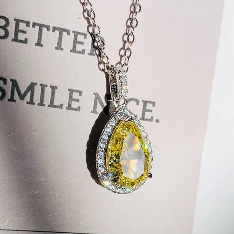 Yellow diamond pendant necklace on a light gray background