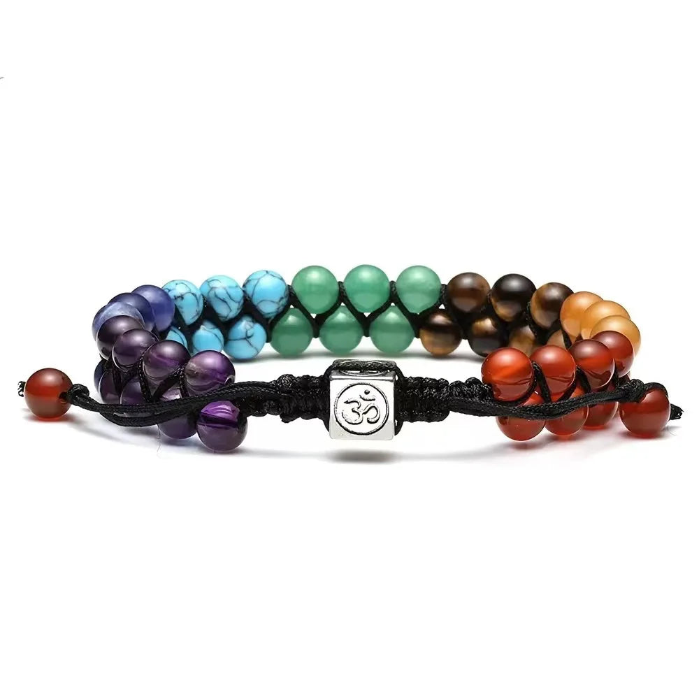 Multicolored beaded bracelet with a silver OM symbol charm on a white background