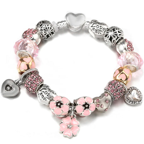 Bracelet with pink and silver charms on a white background