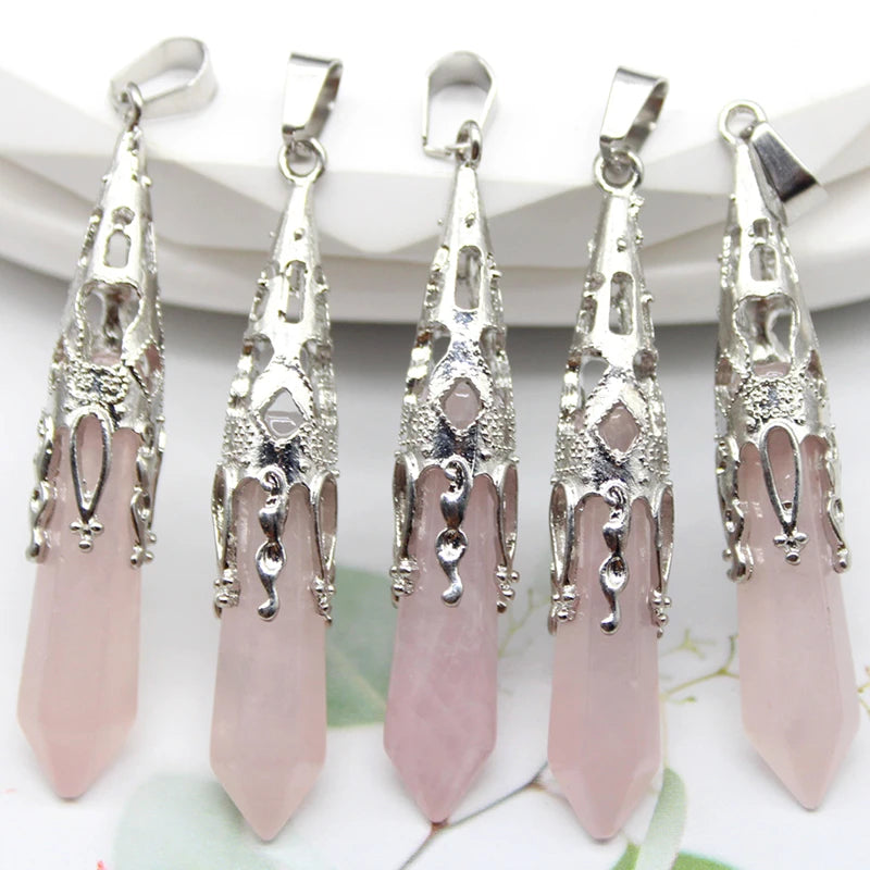 Five silver and pink pendant necklaces on a white background