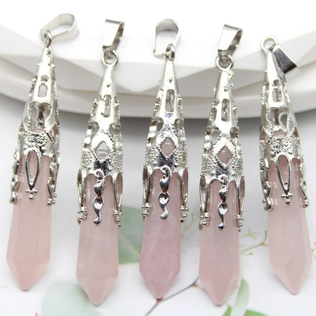 Five silver and pink pendant necklaces on a white background