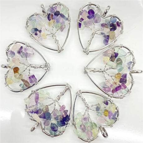 Set of heart-shaped gemstone pendants on a white background
