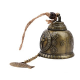Decorative bell with floral designs and hanging charm on a white background
