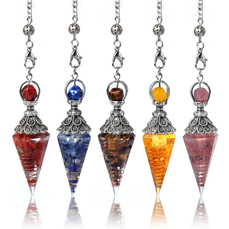 Five colorful crystal pendulums with silver tops on a white background
