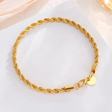 Gold braided bracelet on a white background