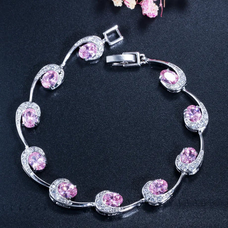 Silver bracelet with pink gemstones on a dark background