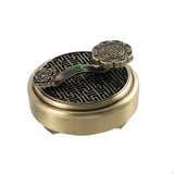 Bronze incense burner with intricate design on a white background
