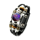 Multistrand bracelet with leather strap and decorative beads on a white background